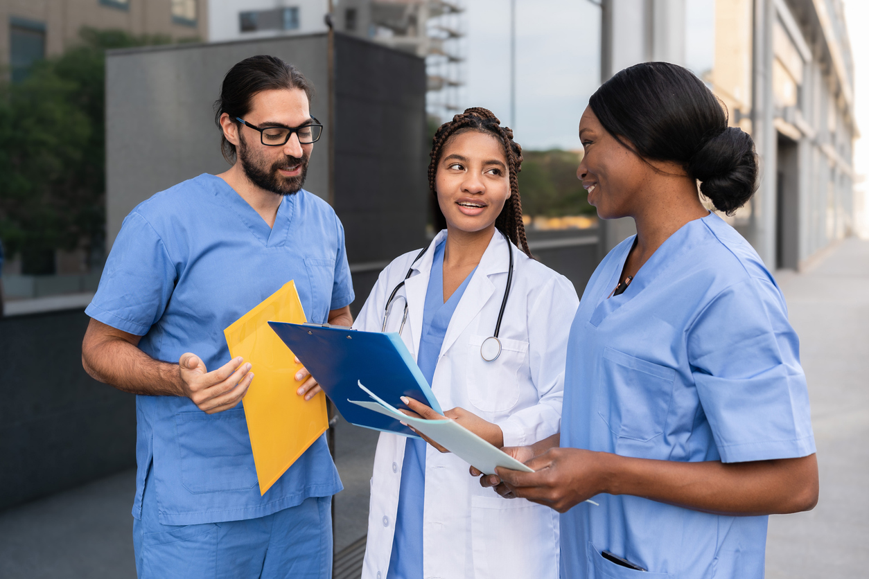 Nurses Standing and Talking Outside of a Medical Facility