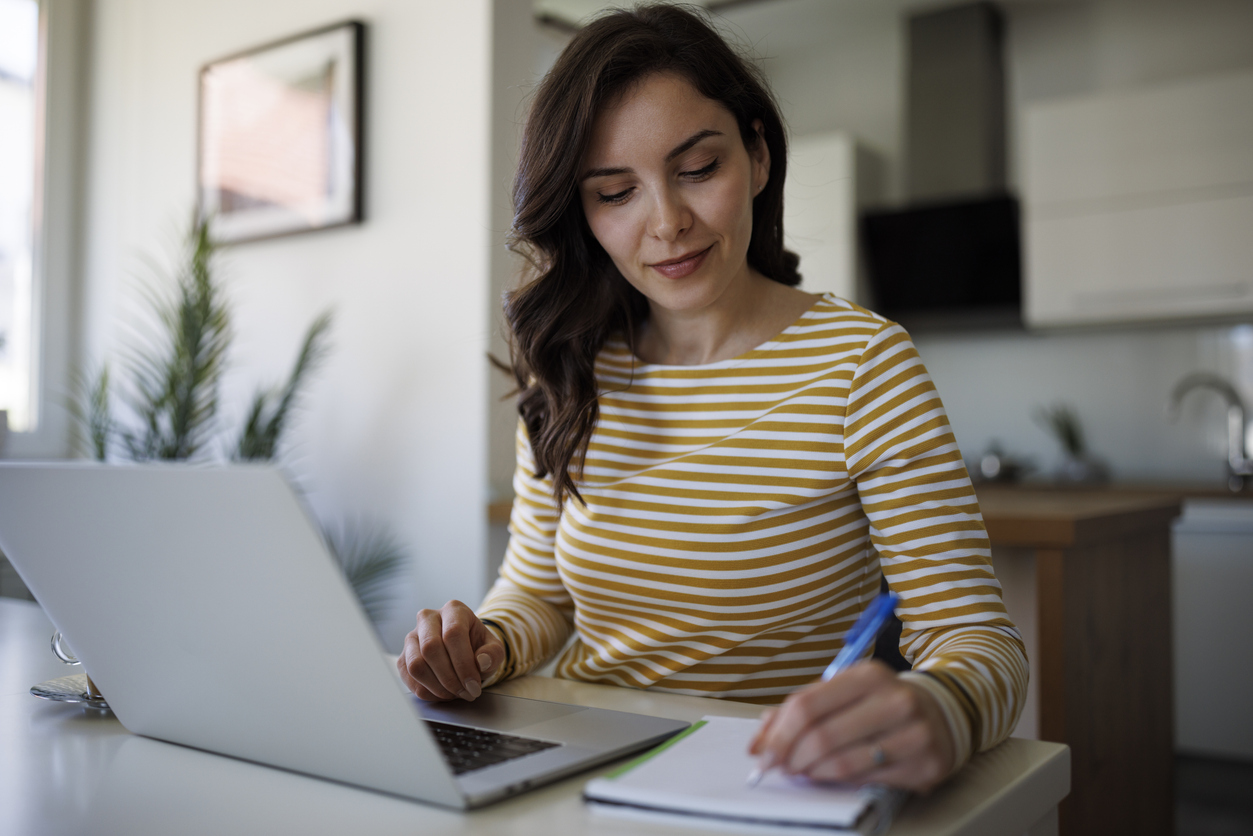 An online student works at home on a laptop.